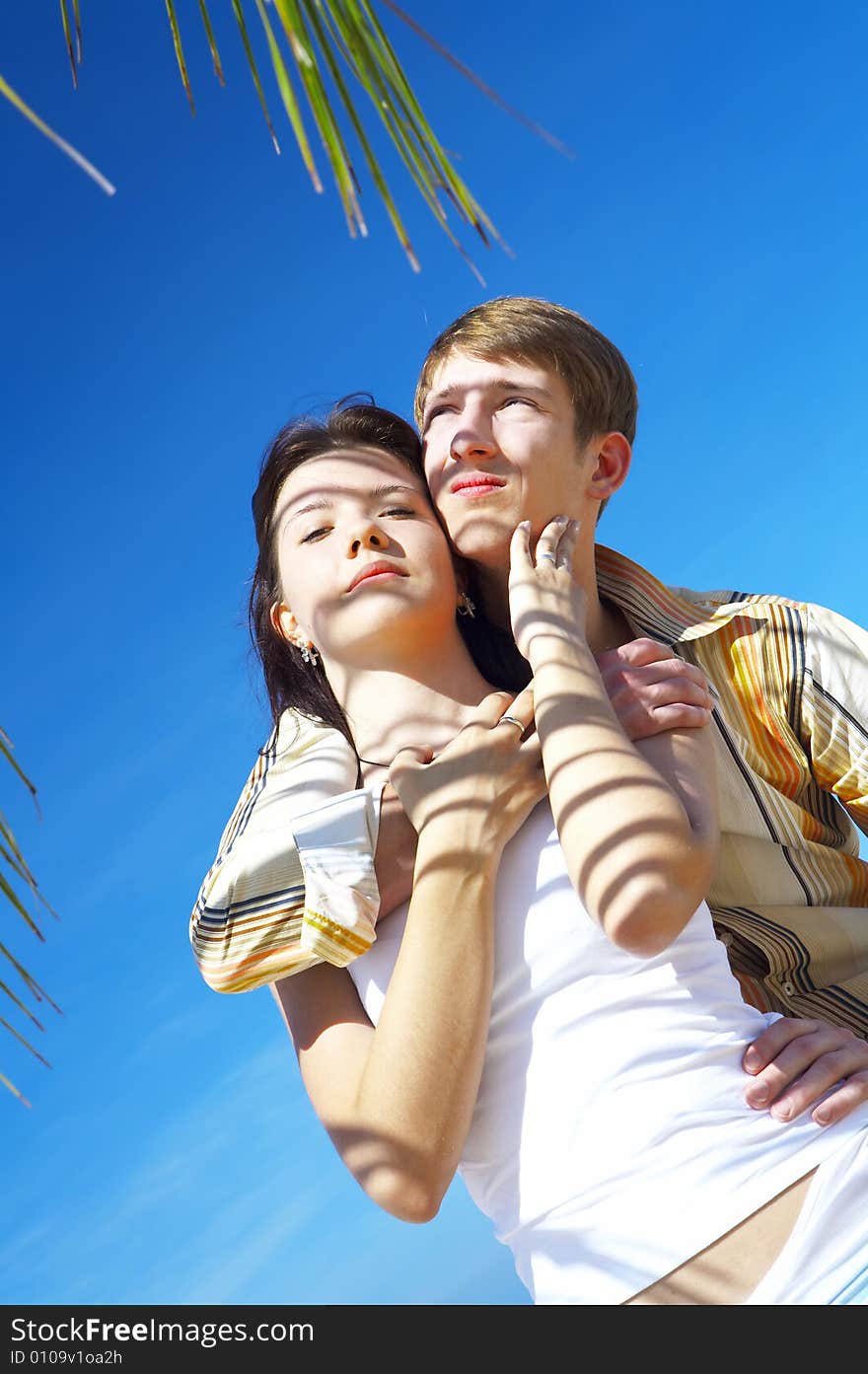 A portrait of attractive couple having date on the beach. A portrait of attractive couple having date on the beach