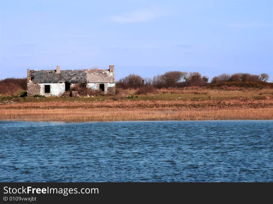 An isolated cottage in the irish country side beside a river. An isolated cottage in the irish country side beside a river