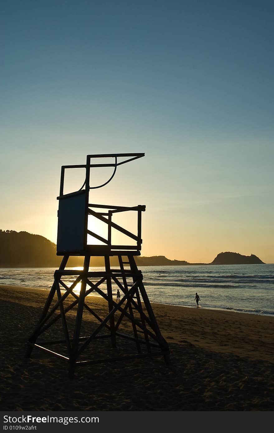 Loneley chair of a lifeguard who has left his post as the sun sets. Loneley chair of a lifeguard who has left his post as the sun sets