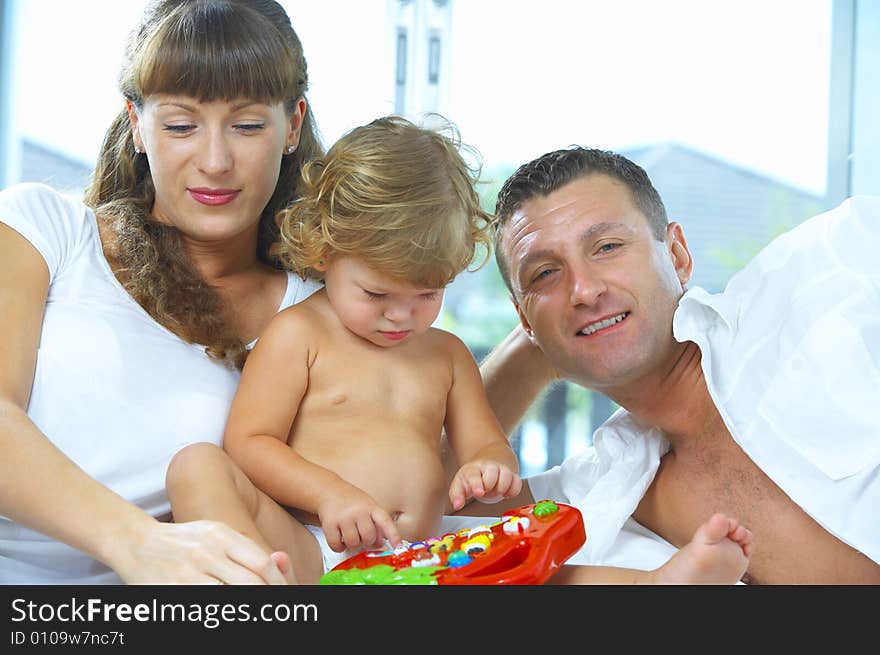 High key portrait of nice young family getting busy. High key portrait of nice young family getting busy