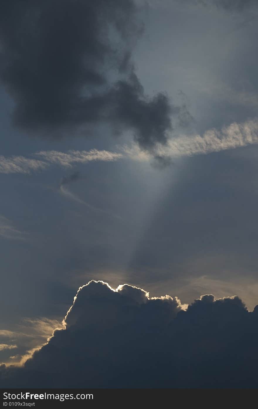 Picture of the sun blast over the beach at sunset about to be engulfed by storm clouds