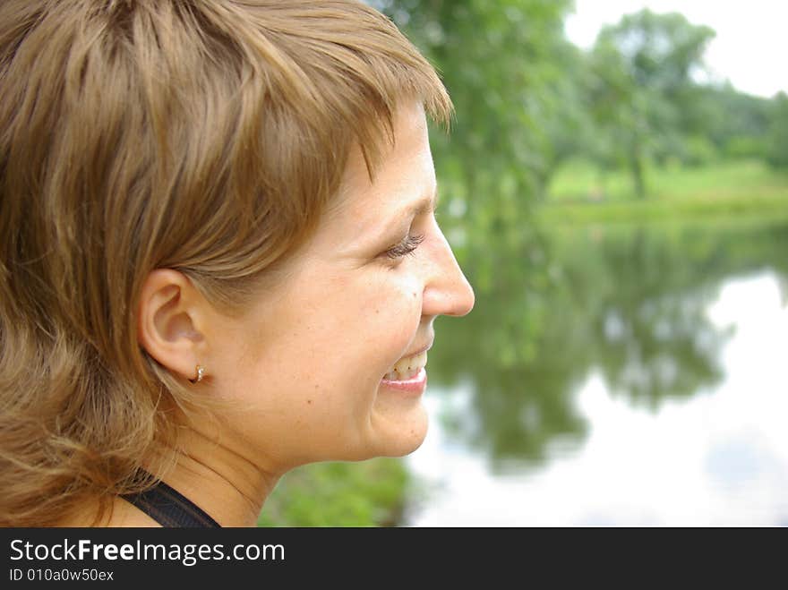 Attractive young woman on the green grass