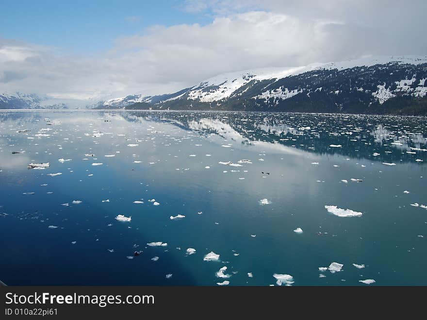 Snowy Mountains reflect off blue waters