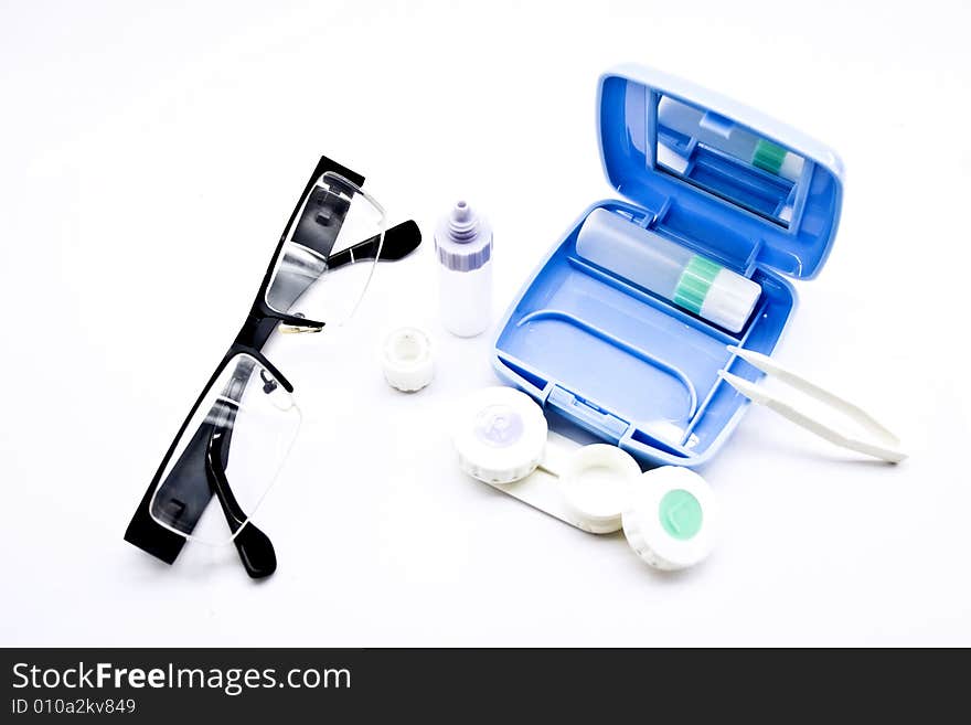 Containers and tweezers for the lens on a white background. Containers and tweezers for the lens on a white background