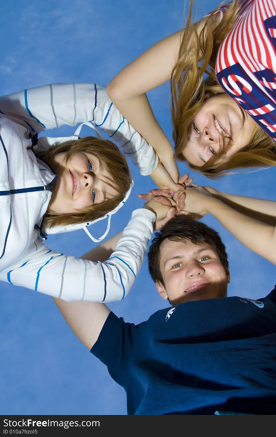 Three Friends On A Background Of The Blue Sky