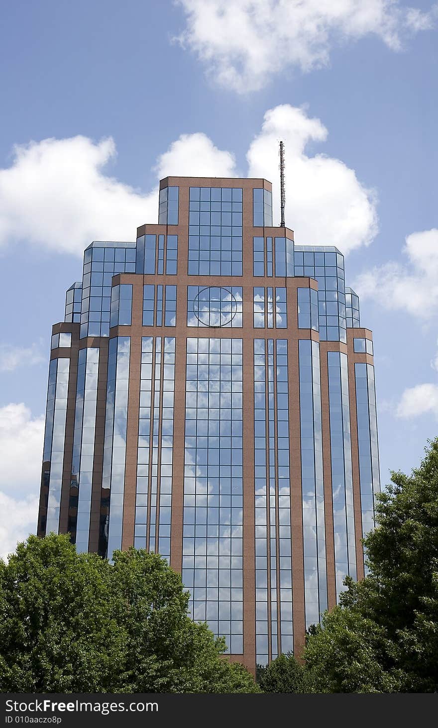 A modern office building of brick and glass reflecting sky and clouds. A modern office building of brick and glass reflecting sky and clouds