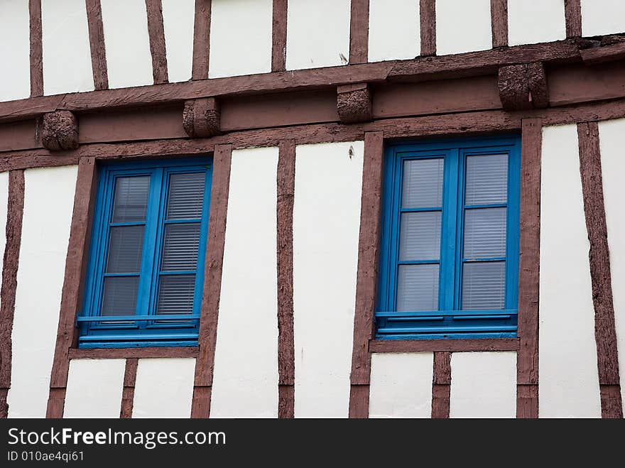 Facade of a typical antique house with deformed beams. Facade of a typical antique house with deformed beams