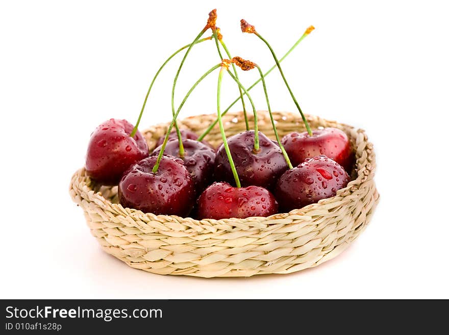 High resolution image of wet fresh cherries in a basket