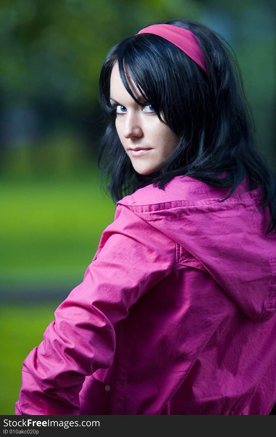 Girl in pink jacket on street