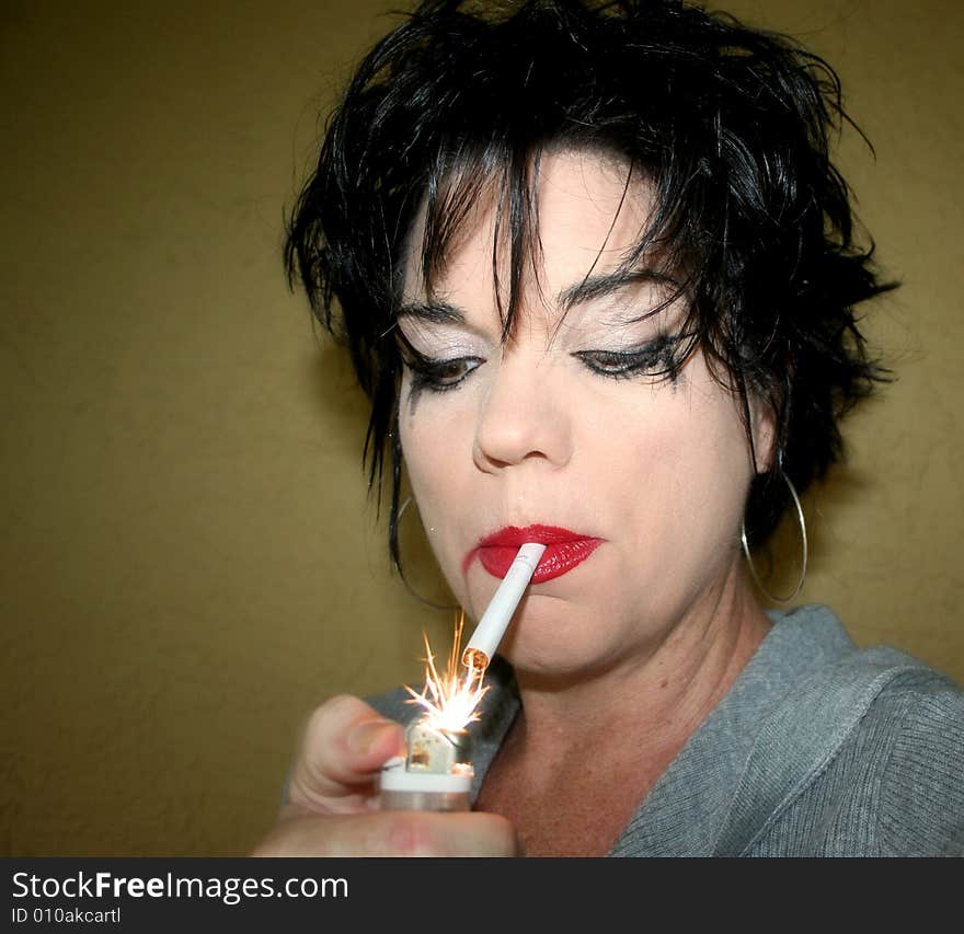 Photo of a woman lighting up a cigarette. Photo of a woman lighting up a cigarette