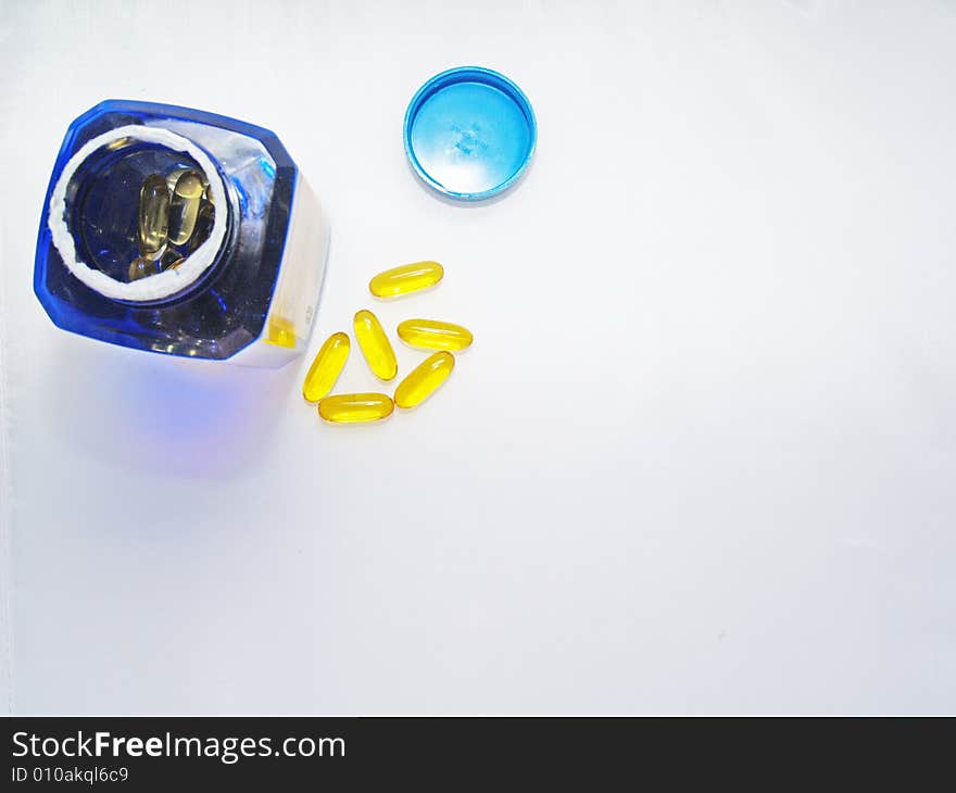 Vitamins  with vitamin bottle and lid on white background