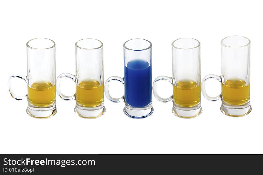 Shot glases with yellow and blue alcohol on white background. Shot glases with yellow and blue alcohol on white background