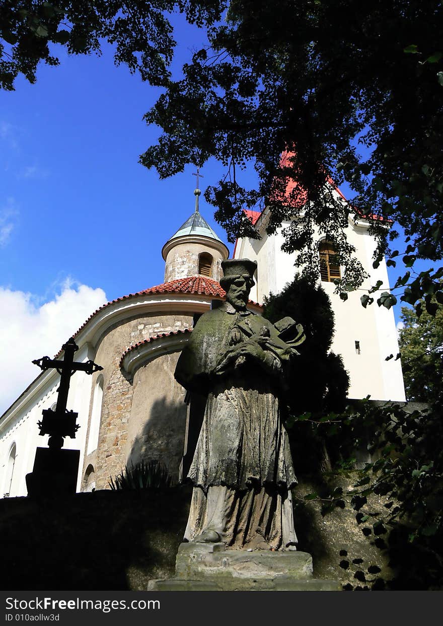 Statue of saint in front of old church (Czech rep.)