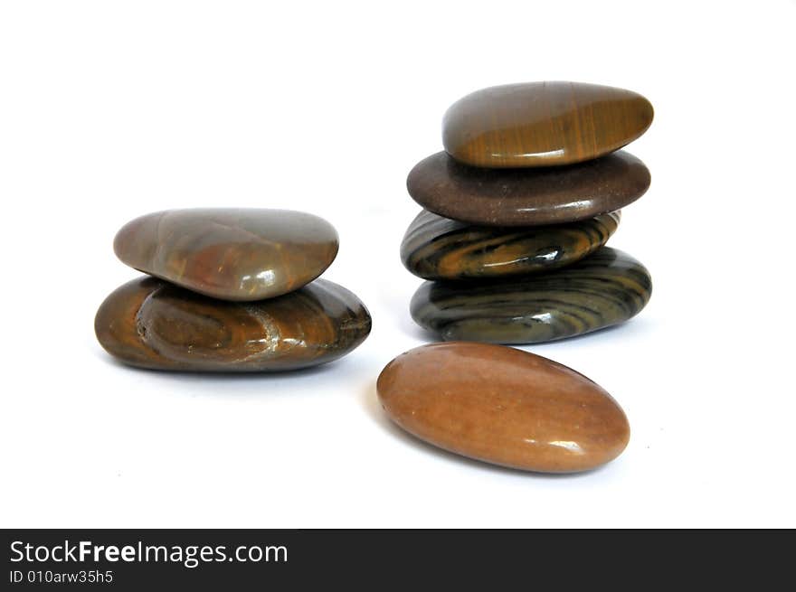 Close up of polished rocks on white background. Close up of polished rocks on white background.