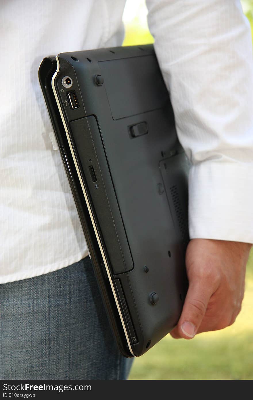 A man carries his computer ready to go to school or work. A man carries his computer ready to go to school or work.