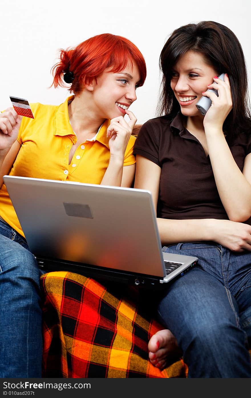 Two young women with laptop and phone. Two young women with laptop and phone