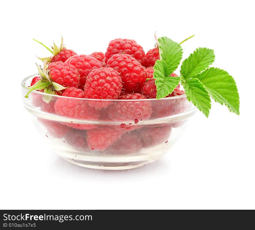 Red raspberry fruits in glass vase