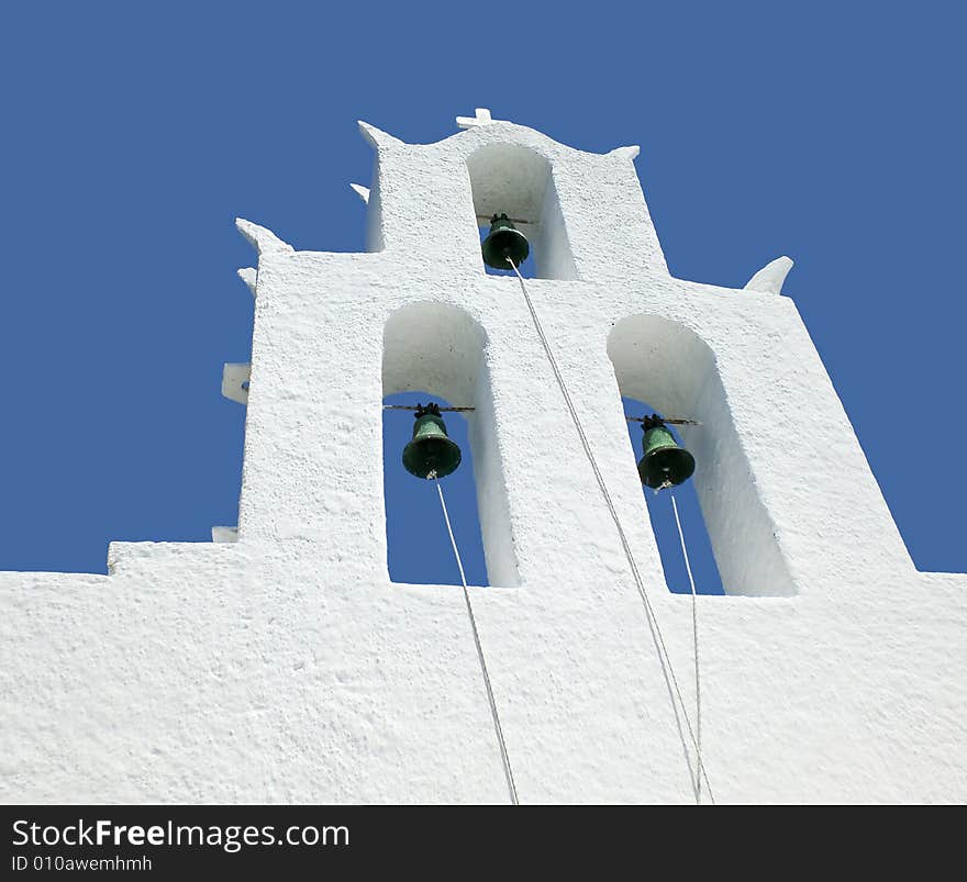 White bell tower of a church in Greece. White bell tower of a church in Greece.