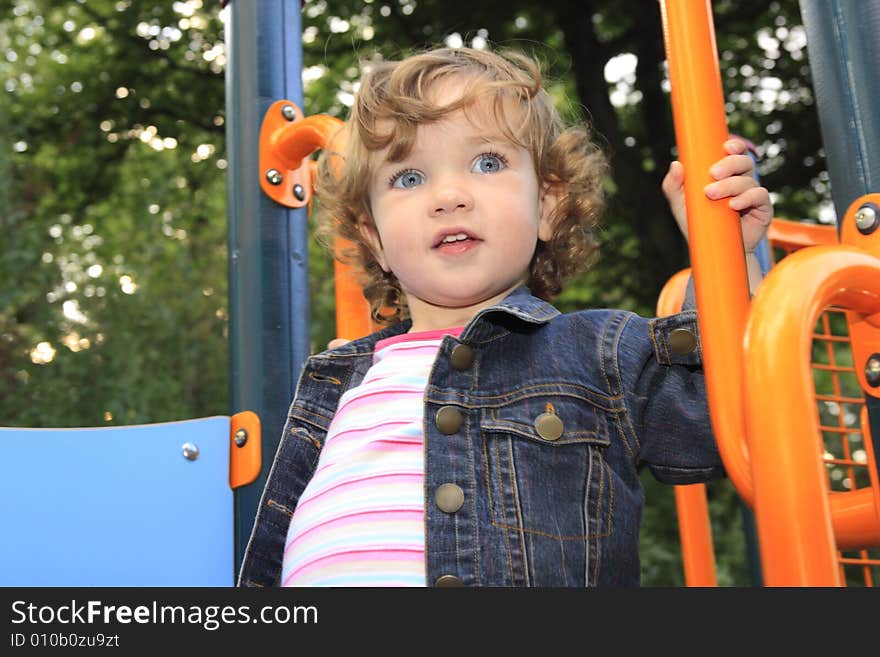 The child is having fun on the playground. The child is having fun on the playground.