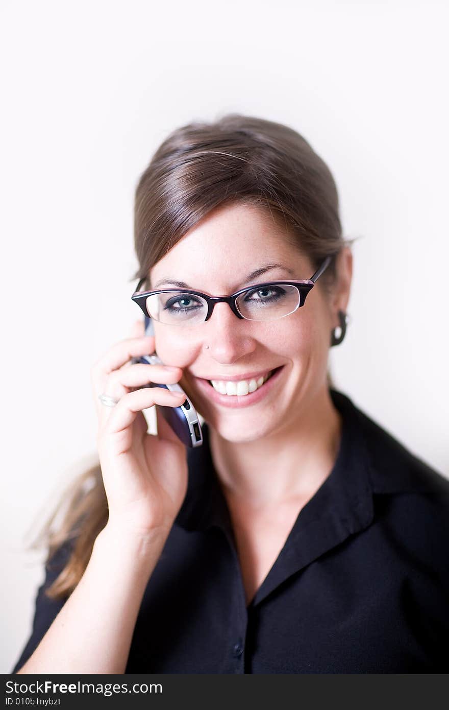 Young modern woman holding cellphone talking.