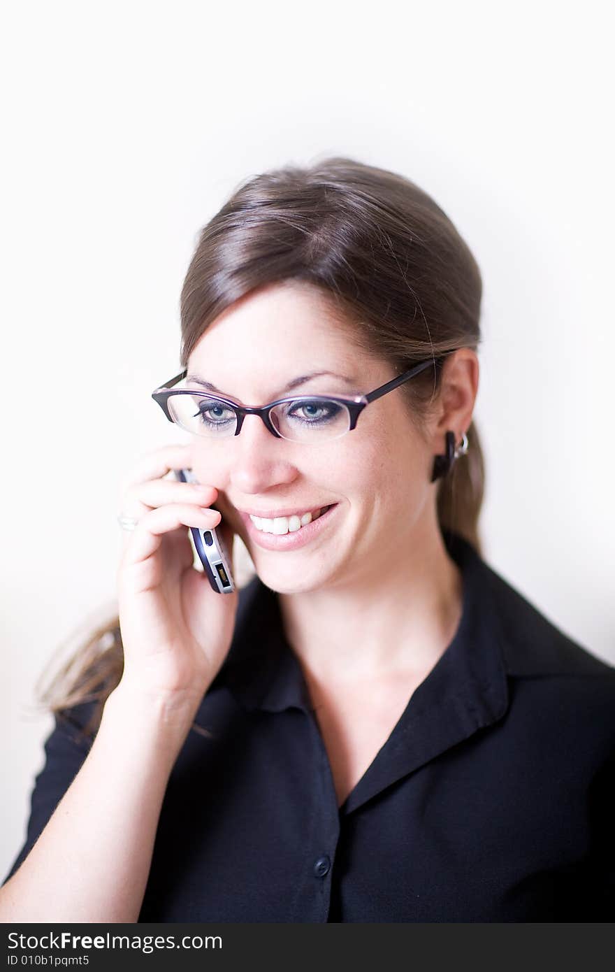 Young modern woman holding cellphone talking.