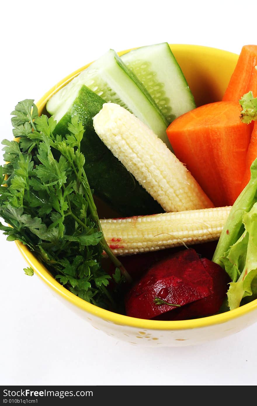 Bowl of fresh vegetables isolated on white.