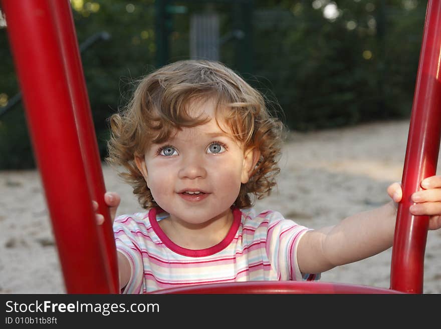 The child is having fun on the playground. The child is having fun on the playground.