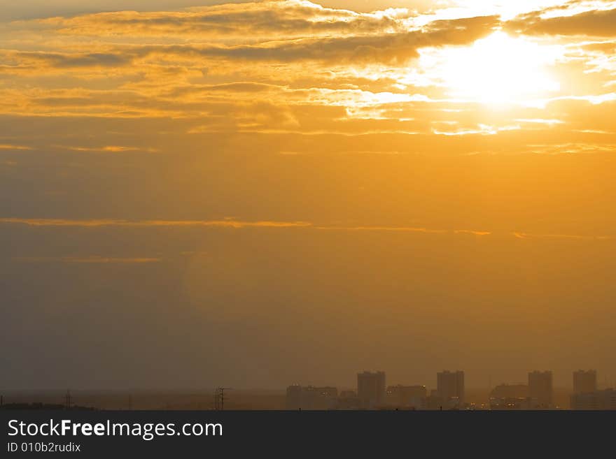 Sunset with clouds and city houses