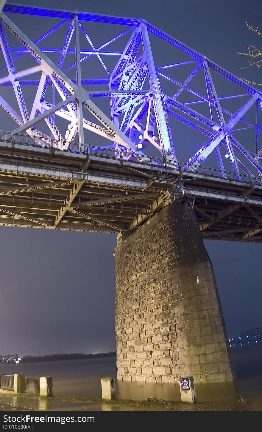 A night time view of the underside of a bridge. A night time view of the underside of a bridge