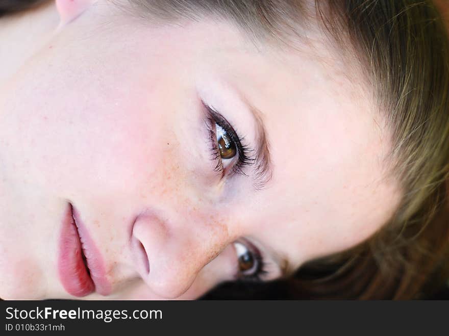 Beauty face of young woman outdoor in the grass. Beauty face of young woman outdoor in the grass