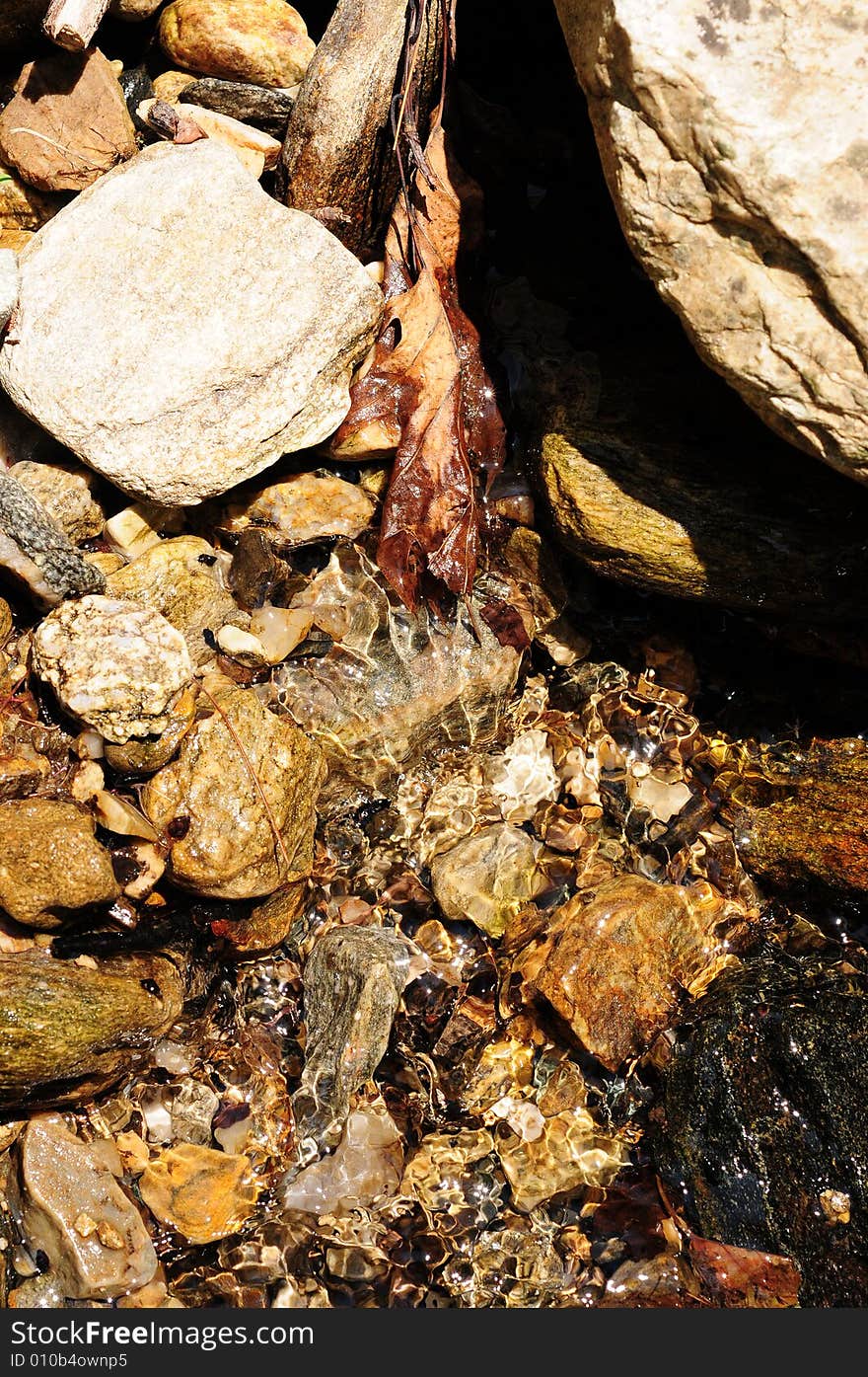 Red rocks in a mountain stream of fresh crystalline water. Red rocks in a mountain stream of fresh crystalline water