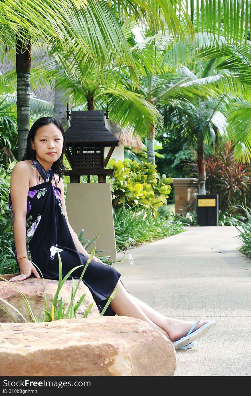 Portrait of a pretty Korean woman at a tropical resort. Portrait of a pretty Korean woman at a tropical resort.