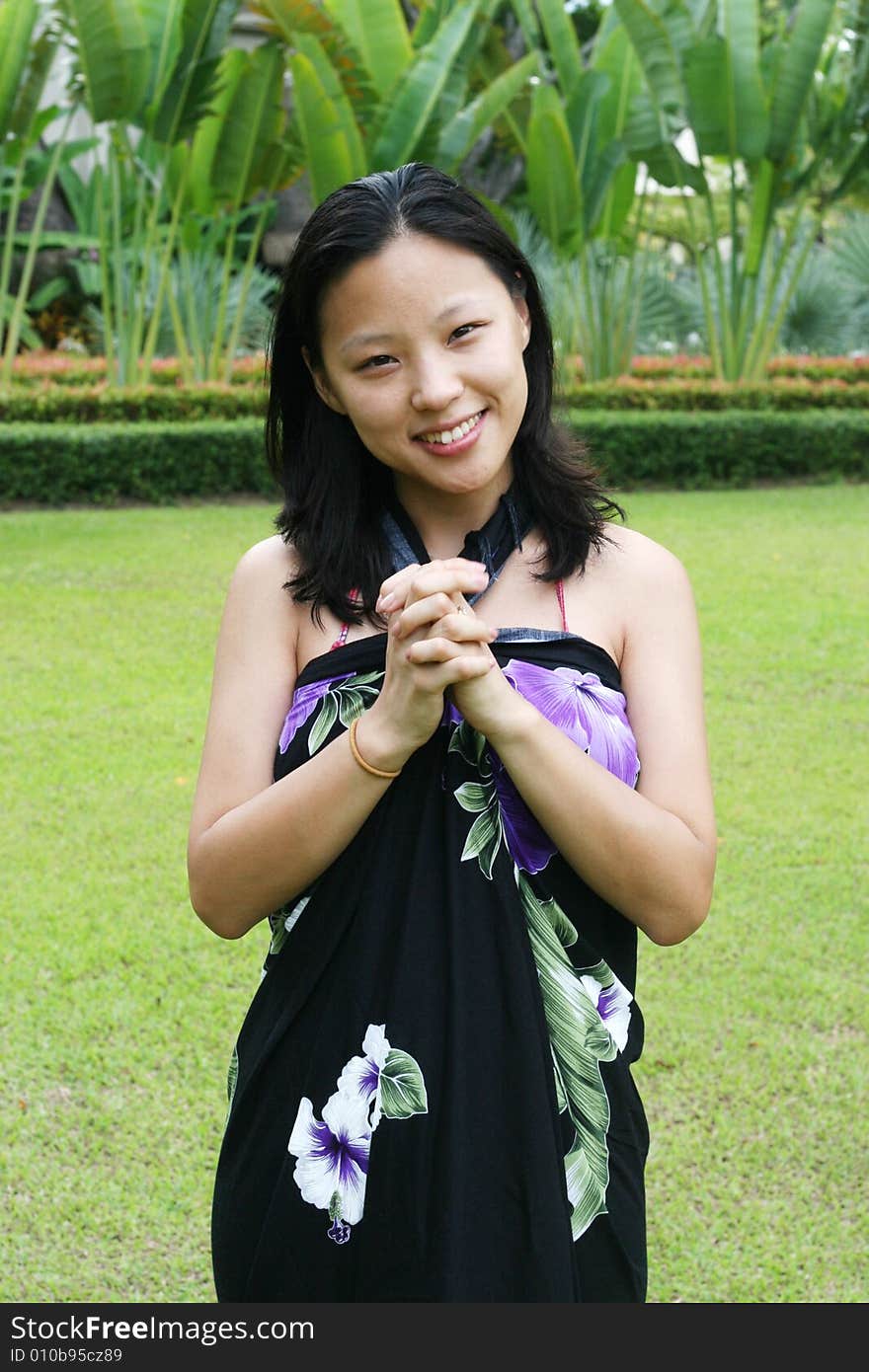 Asian woman in a pretty summer sarong.