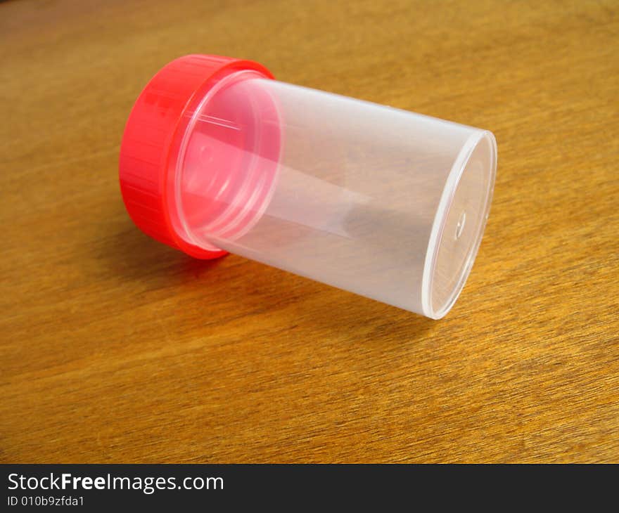 Urine medical container on wooden background