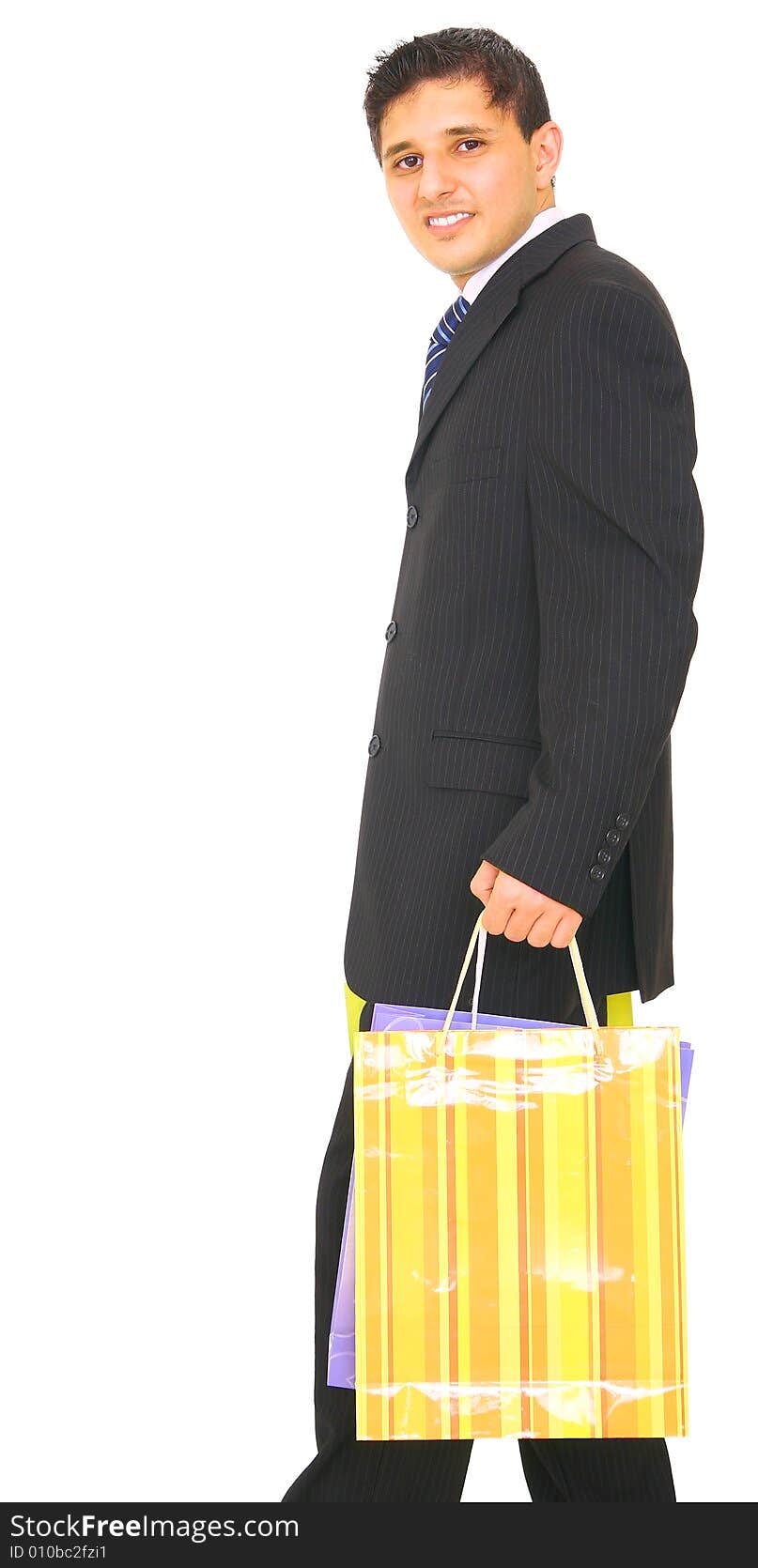 Young business man happily carrying shopping bags. isolated on white background. Young business man happily carrying shopping bags. isolated on white background