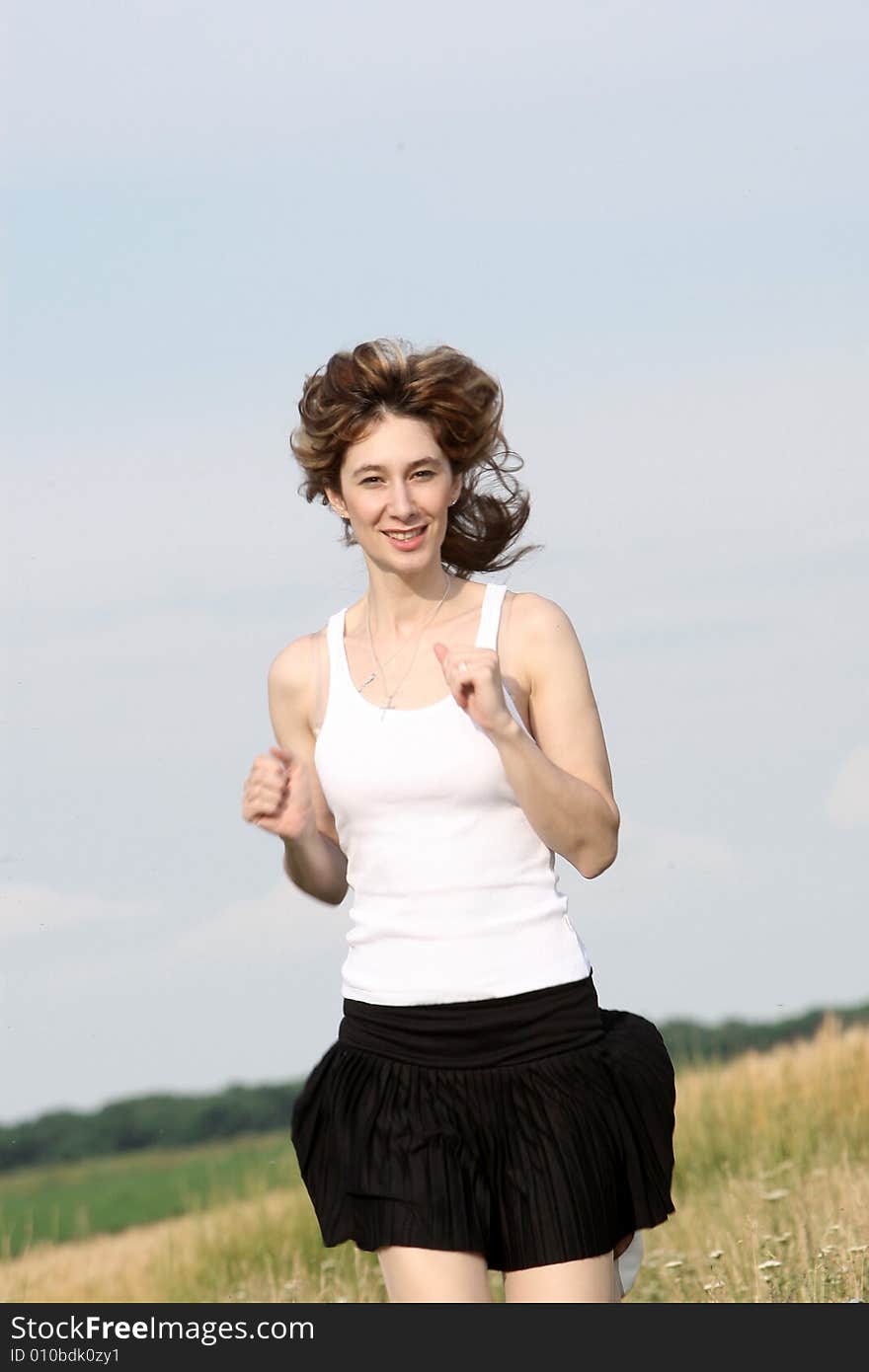 A beautiful girl running on the field