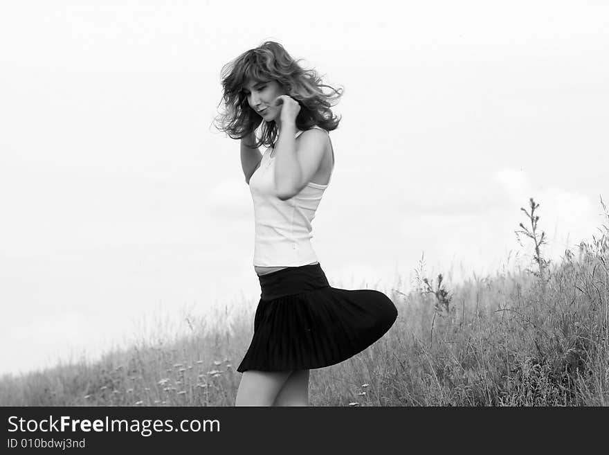 A beautiful girl dancing on the field. A beautiful girl dancing on the field