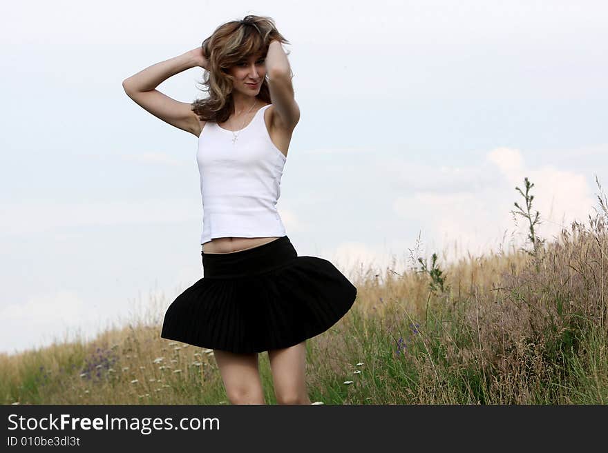 A beautiful girl dancing on the field. A beautiful girl dancing on the field