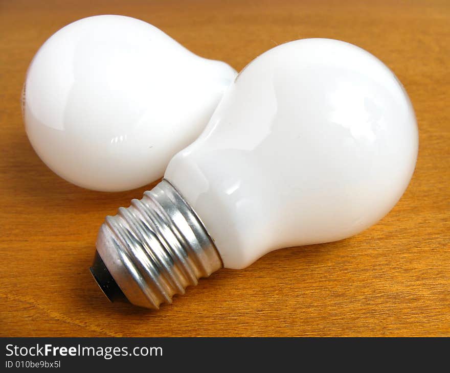 Two White Light bulbs on wood background. Two White Light bulbs on wood background