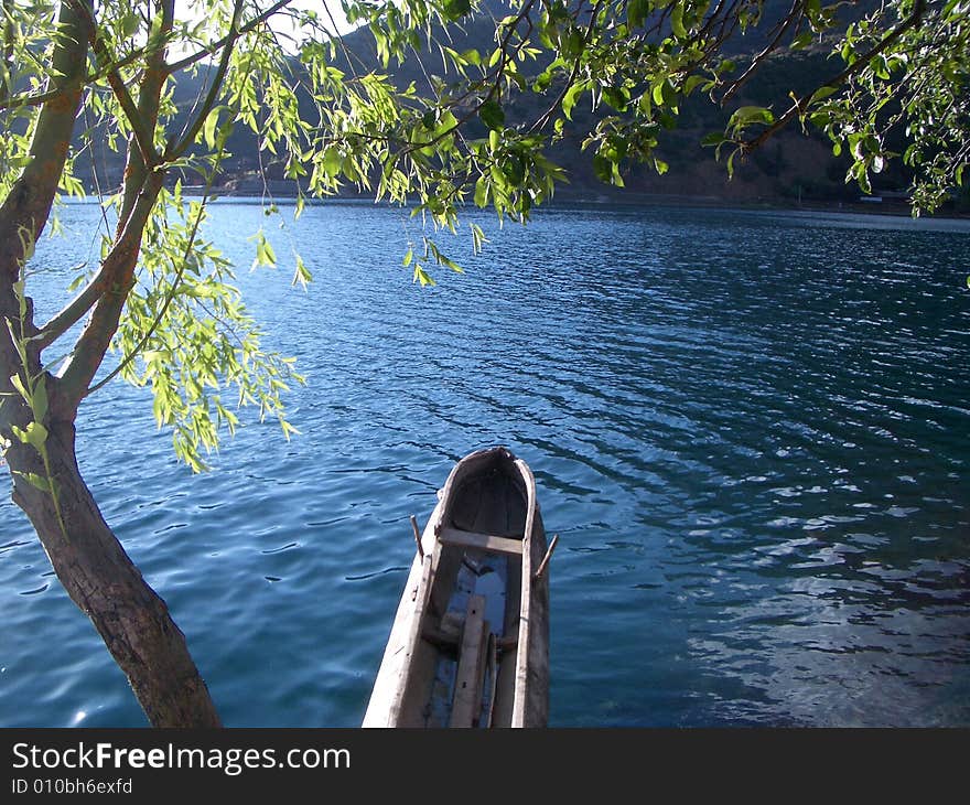 Tree and ship in peaceful lake. Tree and ship in peaceful lake.