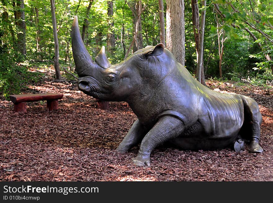 A metal rhinoceros in a public park