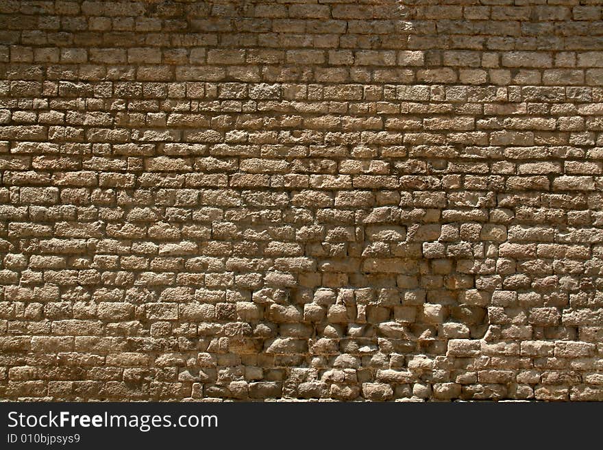 Background or pattern of a broken brick stone wall, historic european church. Background or pattern of a broken brick stone wall, historic european church