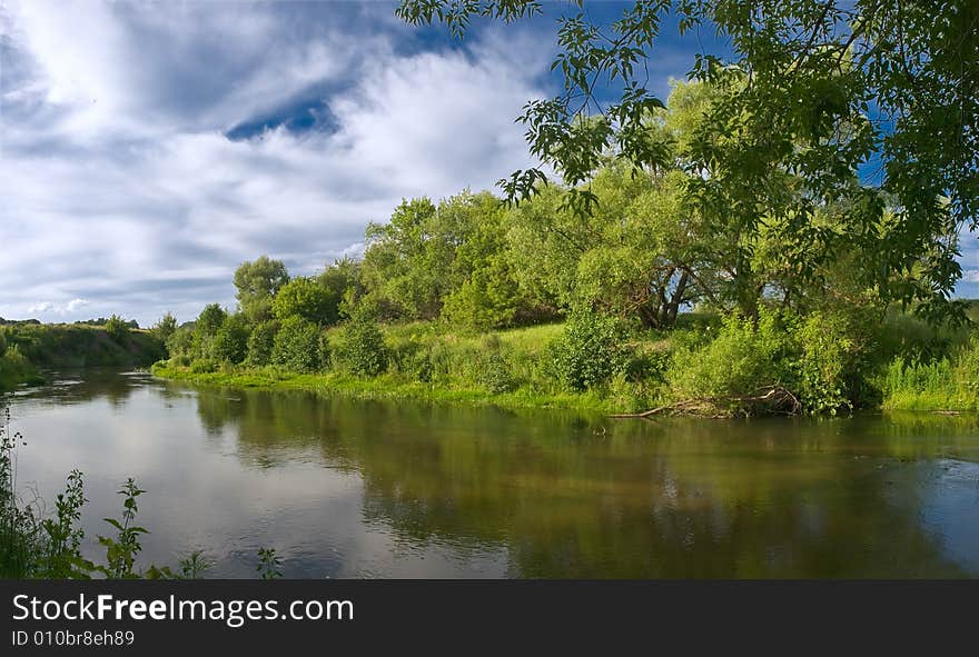 Summer landscape with river, trees, and blue sky with clouds. Summer landscape with river, trees, and blue sky with clouds