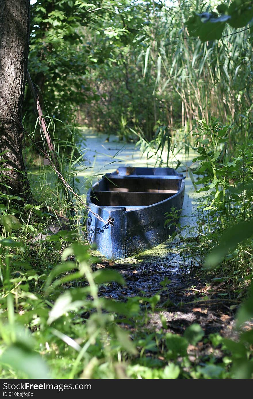 Obsolete wooden boat on a forest lake. Obsolete wooden boat on a forest lake