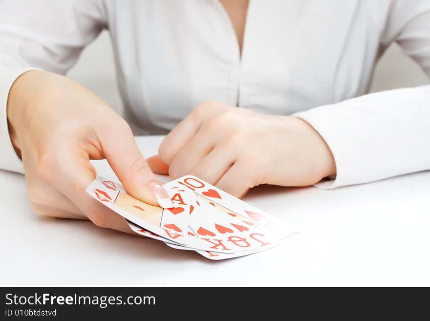 Female hand showing royal flush - ace, king, queen, jack, ten, all in the same suit (hearts). Female hand showing royal flush - ace, king, queen, jack, ten, all in the same suit (hearts)