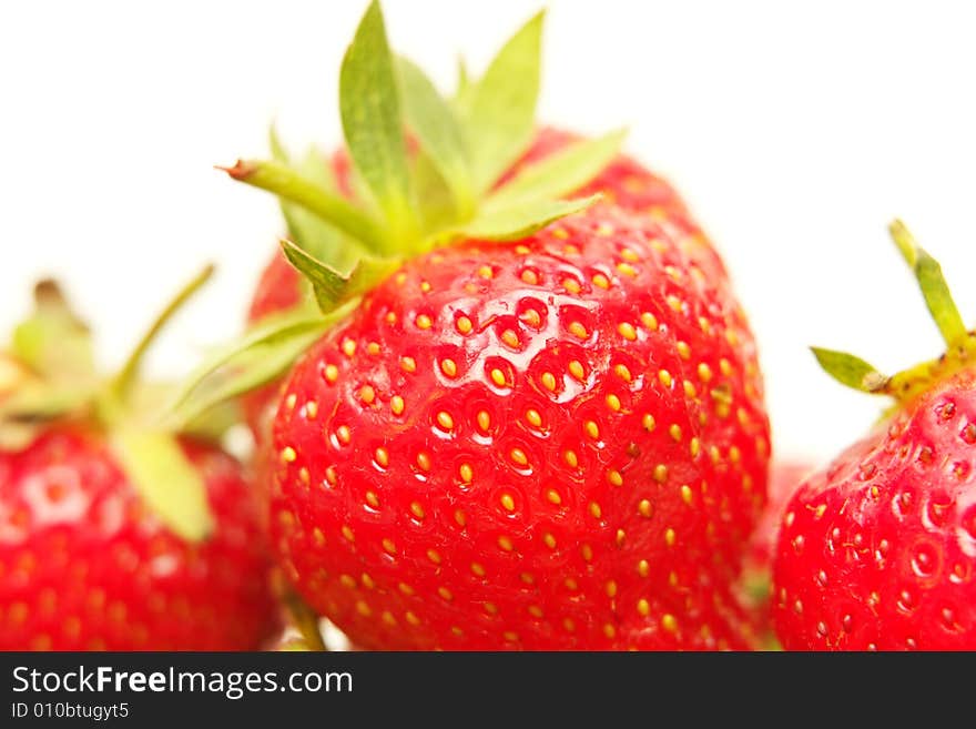 Three fresh strawberries on a white background. Three fresh strawberries on a white background