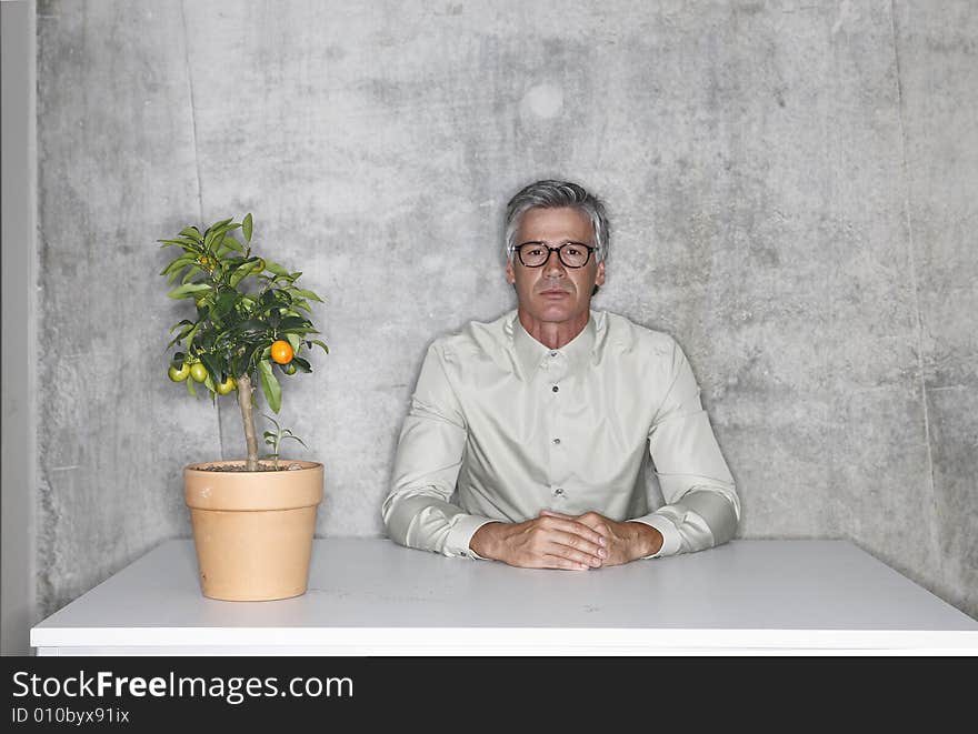 man with plant alone in the room. man with plant alone in the room