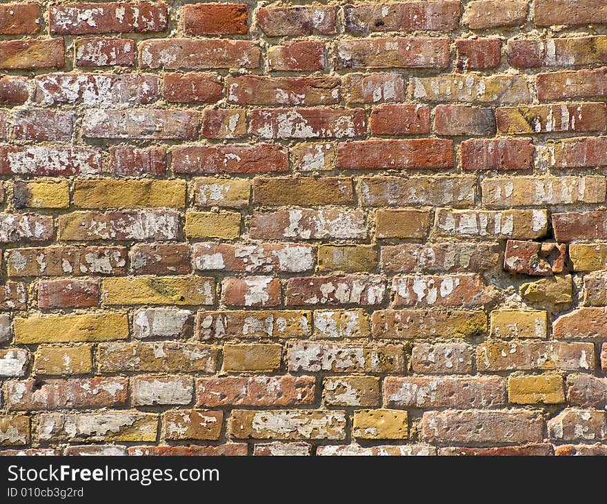 A wall made of old cracked bricks. A wall made of old cracked bricks