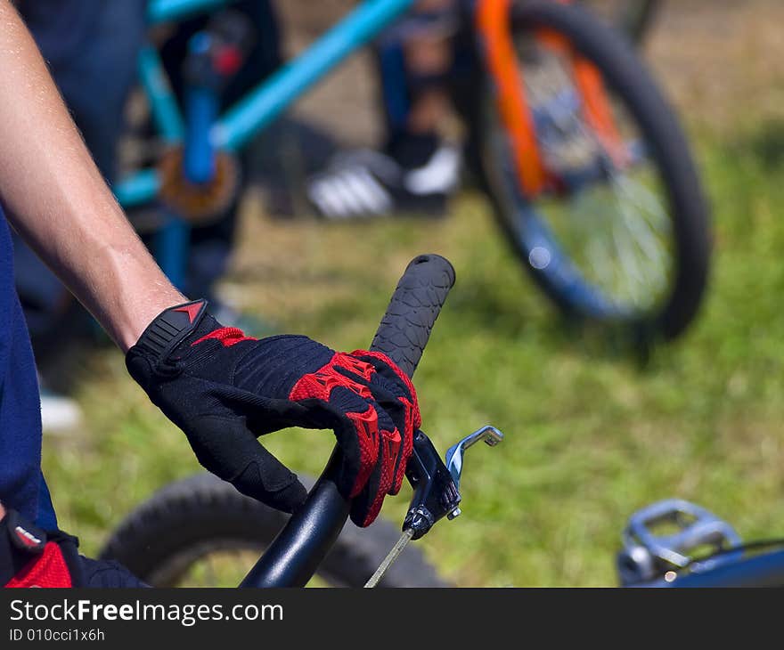 A bmx cyclist hand on the handlebar