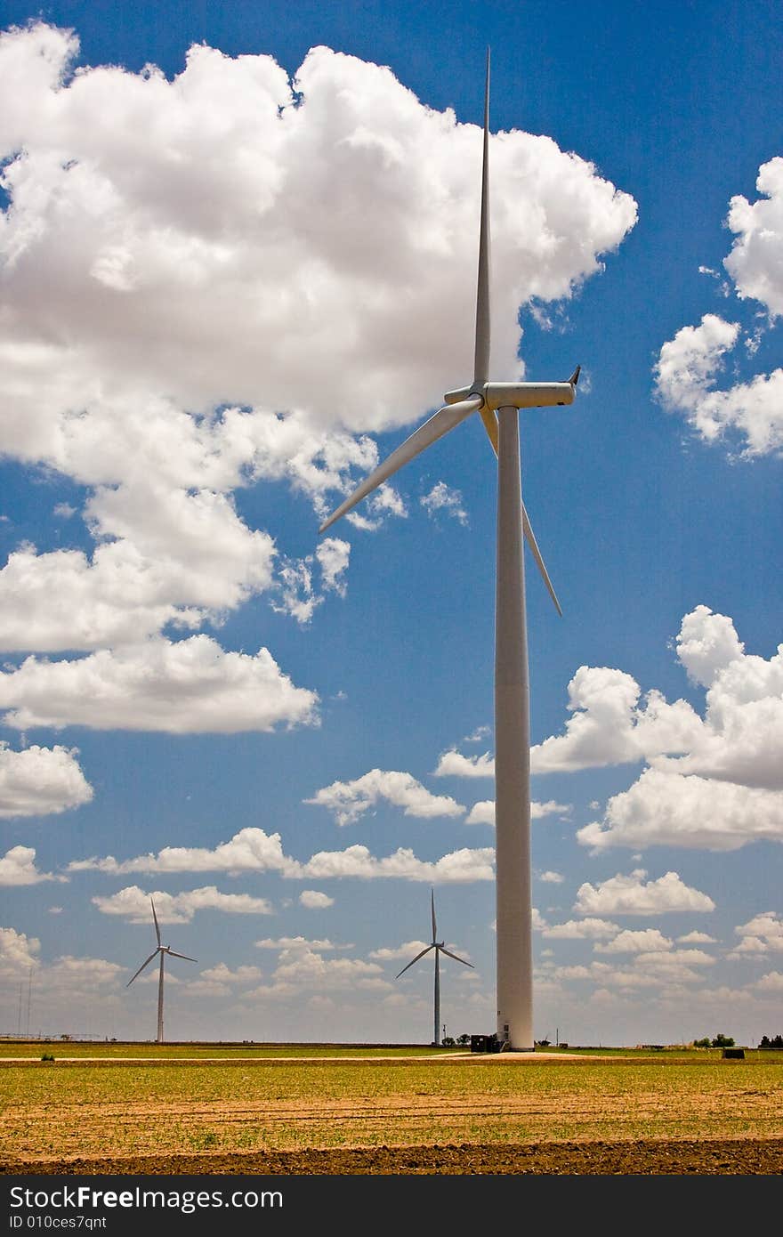 Wind turbines in a row against prairie sky. Wind turbines in a row against prairie sky